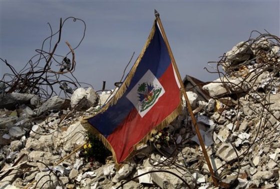 A Haitian flag sits on the rubble of the university of applied languages where 175 students died on Jan. 12 during the earthquake in Port-au-Prince.